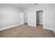 Bedroom featuring neutral carpet, walk-in closet with white shelving, and a window at 1836 Woodpointe Dr, Winter Haven, FL 33884