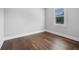 Bright bedroom featuring hardwood floors and a window with natural light at 1836 Woodpointe Dr, Winter Haven, FL 33884