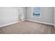 A bedroom featuring neutral carpet, a window with blinds and a glimpse of the lake at 1836 Woodpointe Dr, Winter Haven, FL 33884