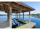 A covered boat lift on a serene lake, showcasing the property's access to waterfront recreation at 1836 Woodpointe Dr, Winter Haven, FL 33884