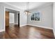Dining room with hardwood floors, modern light fixture, and a window view at 1836 Woodpointe Dr, Winter Haven, FL 33884