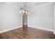 Bright, open dining room with modern light fixture and hardwood floors at 1836 Woodpointe Dr, Winter Haven, FL 33884