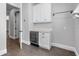 Elegant dry bar with granite countertop, wine fridge, and white cabinets at 1836 Woodpointe Dr, Winter Haven, FL 33884