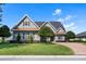 Inviting home with manicured lawn, decorative trees and shrubs, and a brick driveway at 1836 Woodpointe Dr, Winter Haven, FL 33884