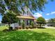Charming home featuring well-maintained landscaping, mature trees, and manicured lawn, enhancing curb appeal at 1836 Woodpointe Dr, Winter Haven, FL 33884