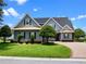 Beautiful single-Gathering home with mature trees, lush lawn, and brick-paved driveway at 1836 Woodpointe Dr, Winter Haven, FL 33884