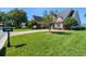 Well-manicured front yard with lush green lawn, mature trees, and a charming home with brick driveway at 1836 Woodpointe Dr, Winter Haven, FL 33884
