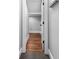 Hallway with hardwood floors leads to a storage area with wire shelving at 1836 Woodpointe Dr, Winter Haven, FL 33884