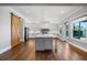 Bright, open kitchen with a large island, stainless steel appliances, and a sliding barn door at 1836 Woodpointe Dr, Winter Haven, FL 33884