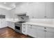 Modern kitchen featuring stainless steel appliances, white cabinets, and a tile backsplash at 1836 Woodpointe Dr, Winter Haven, FL 33884