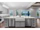 Stylish kitchen island with a farmhouse sink, stainless steel dishwashers, and lake views at 1836 Woodpointe Dr, Winter Haven, FL 33884