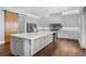 Elegant kitchen featuring a large island, custom cabinets, and a modern barn door at 1836 Woodpointe Dr, Winter Haven, FL 33884