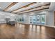 Open-concept living space with hardwood floors, exposed beams, and a view of the pool at 1836 Woodpointe Dr, Winter Haven, FL 33884