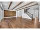 Expansive living room features hardwood floors, a staircase, and a unique wood accent wall at 1836 Woodpointe Dr, Winter Haven, FL 33884