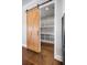 Spacious walk-in pantry featuring custom shelving and a modern sliding barn door at 1836 Woodpointe Dr, Winter Haven, FL 33884
