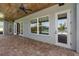 Covered patio with ceiling fan and a view of the pool and waterfront at 1836 Woodpointe Dr, Winter Haven, FL 33884