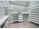 Spacious walk-in closet with custom shelving and drawers at 1836 Woodpointe Dr, Winter Haven, FL 33884
