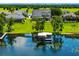 A charming home with solar panels featuring a dock and lift, offering tranquil waterfront living at 1836 Woodpointe Dr, Winter Haven, FL 33884