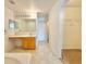 Bathroom features a vanity, mirror, and walk in closet with tiled floors at 1844 Emily Dr, Winter Haven, FL 33884