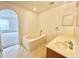 Bright bathroom featuring a vanity, mirror, bathtub, and sink at 1844 Emily Dr, Winter Haven, FL 33884