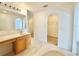 Bright bathroom featuring a vanity, bathtub, and walk in closet with tiled floors at 1844 Emily Dr, Winter Haven, FL 33884