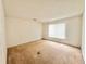 Bright bedroom with carpeted floors and a large window at 1844 Emily Dr, Winter Haven, FL 33884