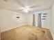 Spacious bedroom featuring a ceiling fan, shelving, and a window with patterned curtains at 1844 Emily Dr, Winter Haven, FL 33884
