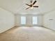 Spacious bedroom features carpet flooring, natural light, and a ceiling fan at 1844 Emily Dr, Winter Haven, FL 33884