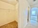 Walk-in closet with carpet flooring and wire shelving, providing ample storage space at 1844 Emily Dr, Winter Haven, FL 33884