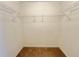 Walk-in closet with carpet flooring and wire shelving, providing ample storage space at 1844 Emily Dr, Winter Haven, FL 33884