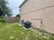 Exterior showcasing the home's AC units and utility access, adjacent to the fenced backyard at 1844 Emily Dr, Winter Haven, FL 33884