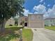 Two story home with a front lawn, a driveway, and a mailbox at 1844 Emily Dr, Winter Haven, FL 33884