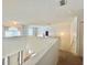 Bright hallway showcasing stairs, a window, and an open floor plan at 1844 Emily Dr, Winter Haven, FL 33884