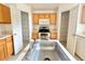 Kitchen sink with stainless steel faucet, wooden cabinets and modern appliances at 1844 Emily Dr, Winter Haven, FL 33884