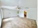 Bright living room featuring carpet flooring and a ceiling fan, offering a cozy atmosphere at 1844 Emily Dr, Winter Haven, FL 33884