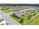 Aerial view of a single-Gathering home on a corner lot with mature trees and sidewalks in a quiet neighborhood at 195 Kissengen Park Blvd, Bartow, FL 33830