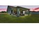 Covered back patio complete with outdoor seating, bar, and string lights, perfect for entertaining at 195 Kissengen Park Blvd, Bartow, FL 33830