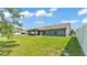 Spacious backyard featuring a covered patio and lush green grass at 195 Kissengen Park Blvd, Bartow, FL 33830