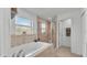 Bathroom with a soaking tub, glass shower, and neutral tile work at 195 Kissengen Park Blvd, Bartow, FL 33830