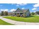 Low angle front exterior of a single-Gathering home with manicured lawn, landscaping, and a two-car garage at 195 Kissengen Park Blvd, Bartow, FL 33830