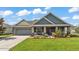 Inviting single-Gathering home with beautiful curb appeal, featuring a lush green lawn and mature landscaping at 195 Kissengen Park Blvd, Bartow, FL 33830