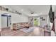 Bright living room with hardwood floors, cozy sofa, and large TV at 195 Kissengen Park Blvd, Bartow, FL 33830
