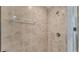 Close-up of shower showcasing neutral tile, glass door, and shower head at 195 Kissengen Park Blvd, Bartow, FL 33830