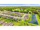 A neighborhood aerial view with manicured lawns, community pond, and lush surroundings at 1976 Harvest Landing Cir, Lakeland, FL 33810