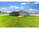 Lush backyard with a screened in lanai, trees and an irrigation system at 1976 Harvest Landing Cir, Lakeland, FL 33810