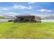 Expansive backyard with lush green grass, screened-in lanai, and a well-maintained fence at 1976 Harvest Landing Cir, Lakeland, FL 33810