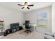 Bright bedroom featuring a ceiling fan, desk and chair, and ample natural light from the window at 1976 Harvest Landing Cir, Lakeland, FL 33810