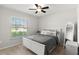 Comfortable bedroom with natural light, a cozy bed, and a mirror at 1976 Harvest Landing Cir, Lakeland, FL 33810