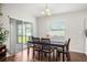 Cozy dining area featuring a table with seating for six, large windows and sliding glass doors at 1976 Harvest Landing Cir, Lakeland, FL 33810