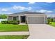 Charming one-story home with a well-manicured lawn and a two-car garage at 1976 Harvest Landing Cir, Lakeland, FL 33810